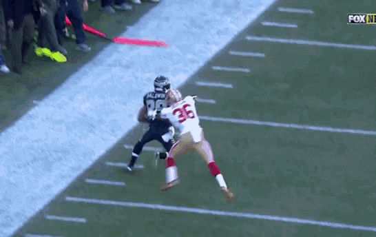 a football player with the number 36 on his jersey is being tackled by another player