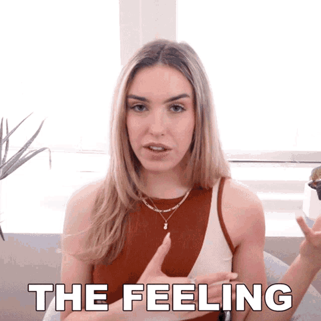 a woman sitting in front of a window with the words " the feeling " written above her