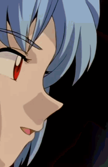a close up of a person 's face with blue hair