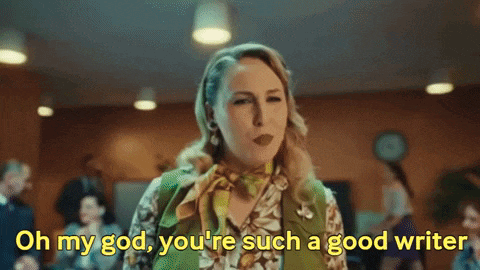 a woman in a green vest and scarf is saying oh my god you 're such a good writer .