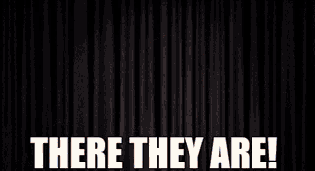 a man with a clown nose is holding a piece of paper and says there they are !
