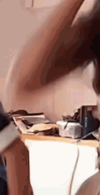 a person is sitting at a table with a bunch of papers on it and looking at something .