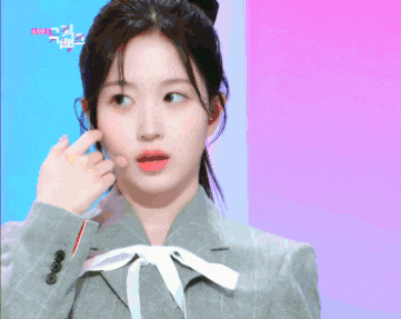 a girl in a suit and tie with the word love on the bottom