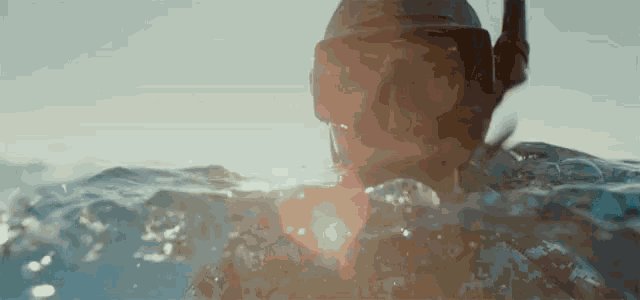 a person is swimming in the ocean wearing a mask and goggles