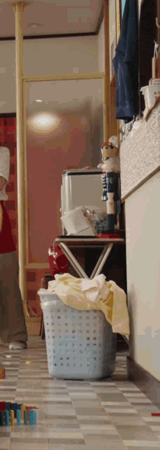 a laundry basket filled with clothes sits on the floor