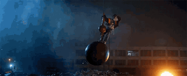 a large ball is hanging from a rope in the air
