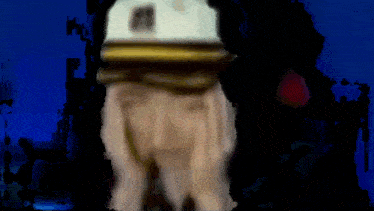 a blurry picture of a man wearing a white hat with the letter m on it
