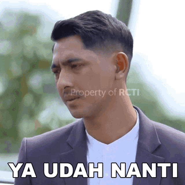 a man in a suit says ya udah nanti on the bottom