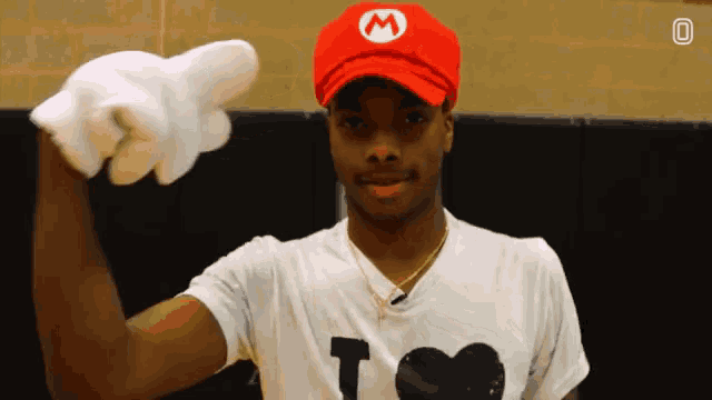 a man wearing a mario hat and gloves