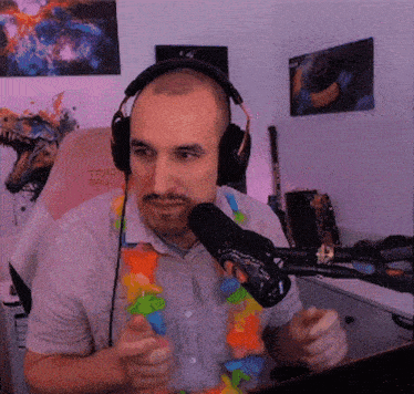 a man wearing headphones stands in front of a microphone