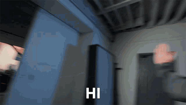 a blurry picture of a person saying hi with their hand