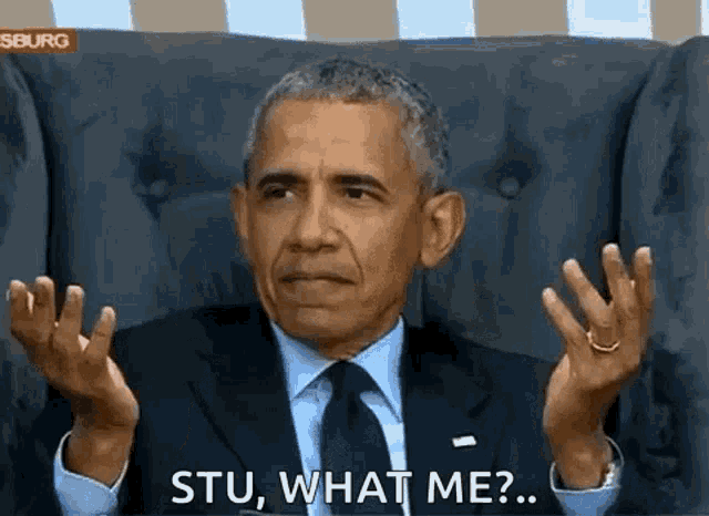 barack obama is sitting in a chair making a funny face and asking , stu , what me ?