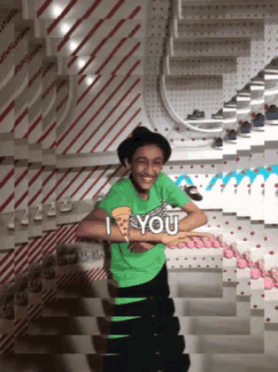 a boy in a green shirt that says i you