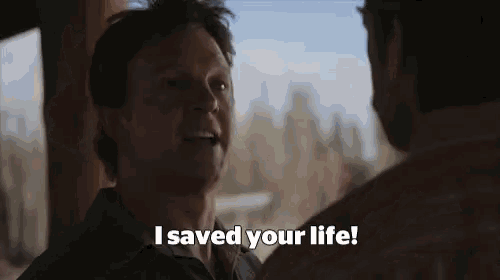 a man is talking to another man in a room and saying `` i saved your life '' .