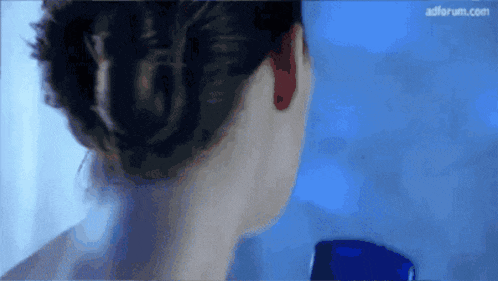 a close up of a woman 's ear with adforum.com written on the bottom