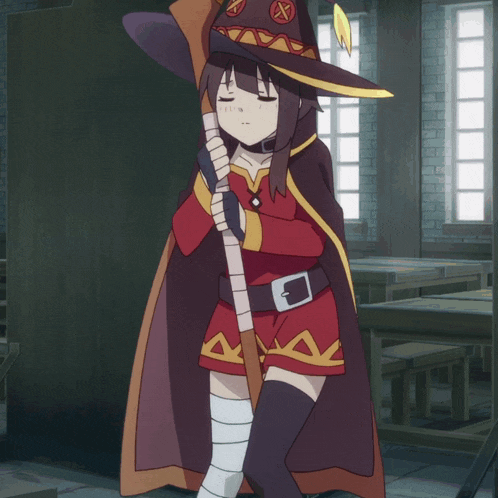 a girl wearing a red cape and a hat with a x on it