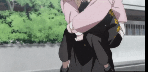 a woman in a pink shirt is carrying a man in black pants