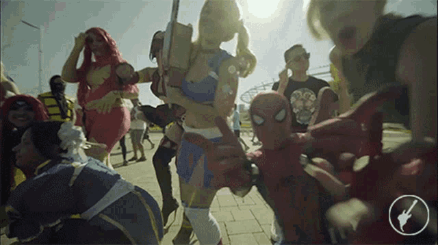 a group of people dressed up in superhero costumes are walking down a street