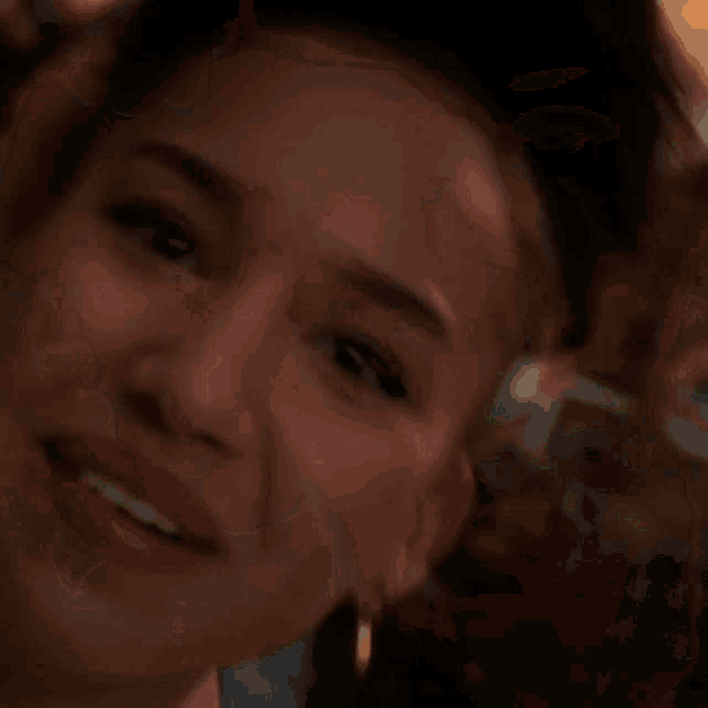 a close up of a woman 's face with a gold earring