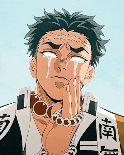 a man with chinese writing on his shirt is crying with tears running down his face