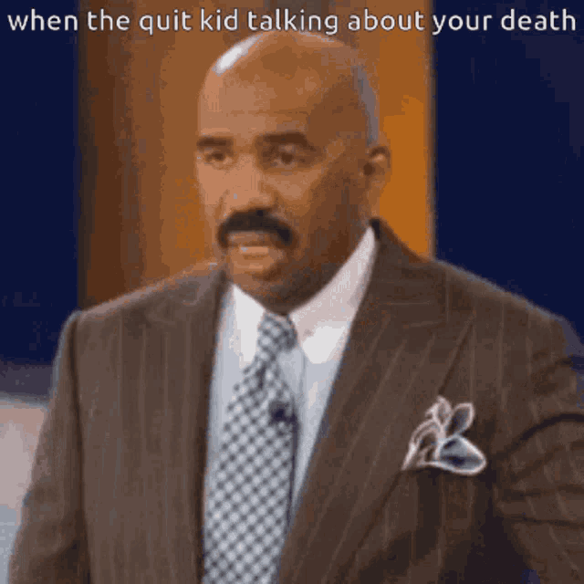 a man in a suit and tie is talking about death