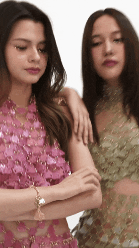 a woman in a pink top is standing next to another woman