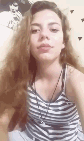 a girl with long hair wearing a striped shirt and a necklace
