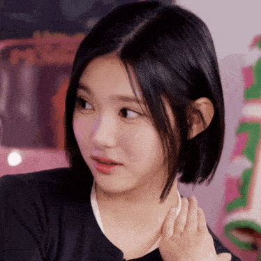 a close up of a girl 's face with a pink sign in the background that says ' a few cents '