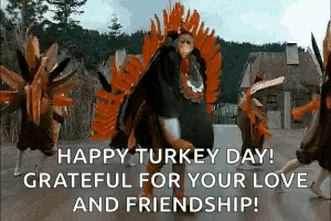 a group of people dressed as turkeys are dancing in front of a thatched building .