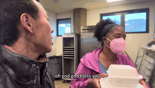a woman wearing a pink mask holds a styrofoam container and says " oh god god bless you "