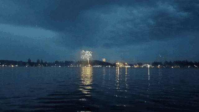 fireworks display over a lake at night
