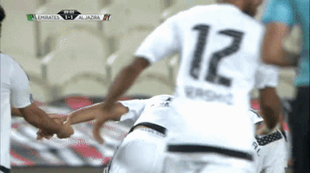 a soccer player with the number 12 on the back of his shirt