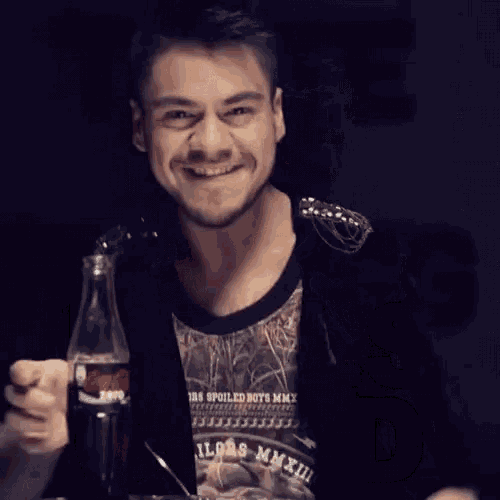 a man with a bottle of coca cola behind him and the words feels good