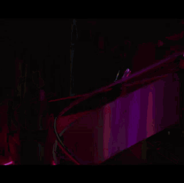 a woman in a red cape stands next to a man in a black suit on a set of stairs