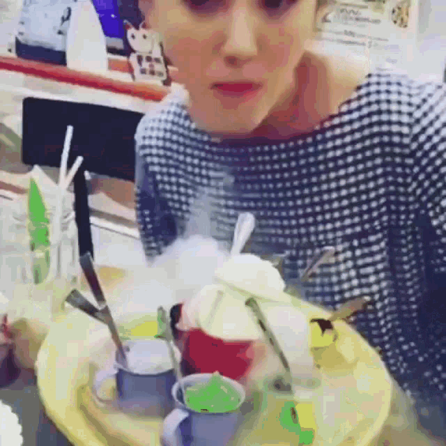 a woman is sitting at a table with a plate of food on it .