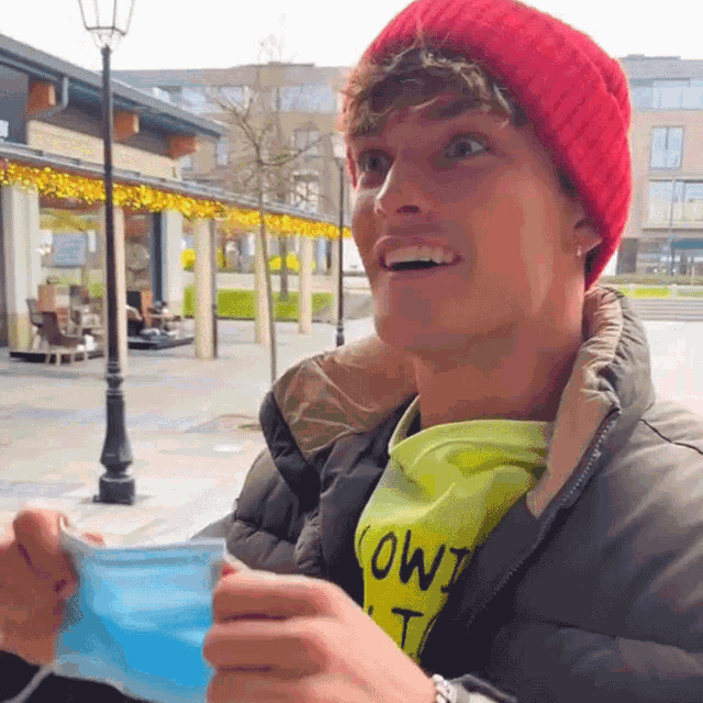 a man wearing a red hat and a yellow shirt that says owl