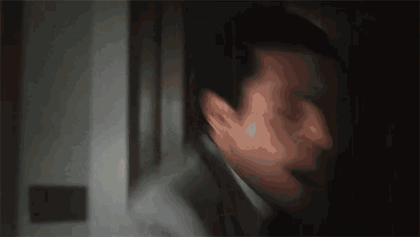 a blurry picture of a man 's face with his mouth open