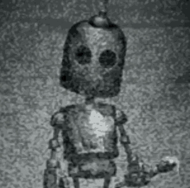 a black and white photo of a cartoon robot holding a torch .