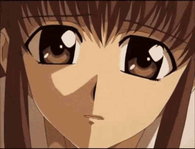 a close up of a girl 's face with a serious look on her face