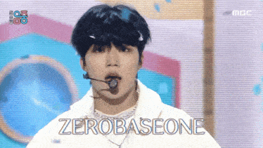 a young man singing into a microphone with the words zerobaseone written below him