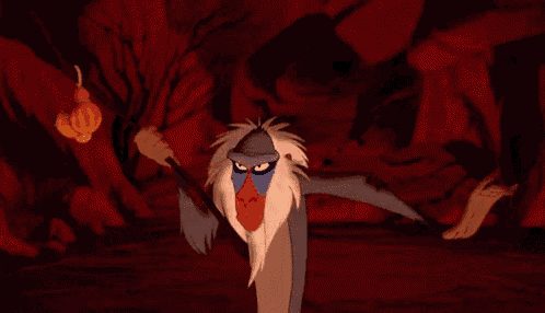 a cartoon baboon is standing next to a hyena in a cave with its mouth open .