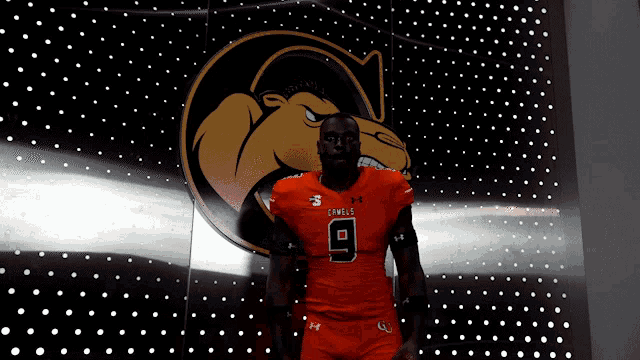 a football player wearing an orange uniform with the number 9 on it