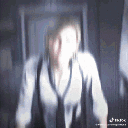a blurry picture of a woman with a tiktok watermark on the bottom