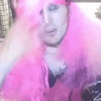 a man wearing a pink wig and a hat
