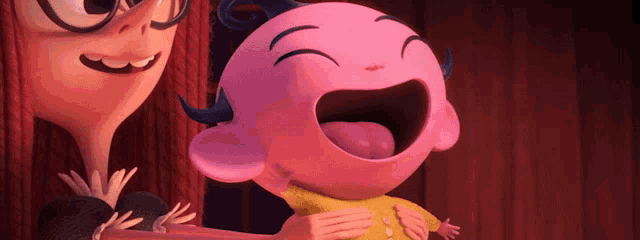 a woman is holding a pink cartoon character with her mouth open