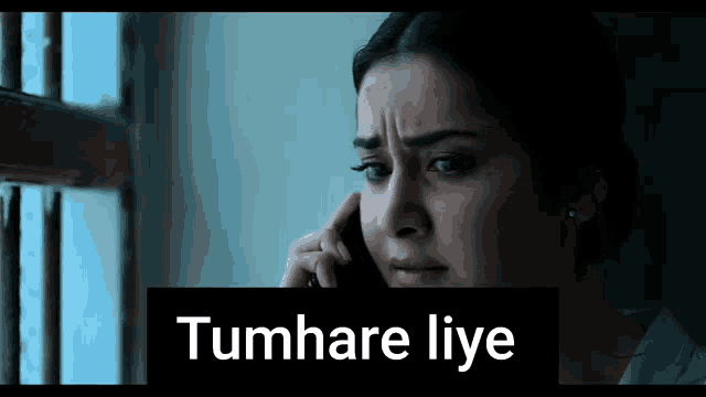 a woman talking on a cell phone with the words tumhare liye written below her