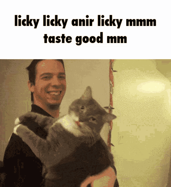 a man is holding a cat that says licky licky amir licky mm taste good mm