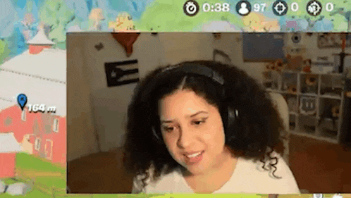 a woman wearing headphones is playing a video game on a computer screen .