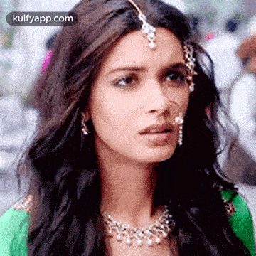 a woman is wearing a nose ring and a necklace .