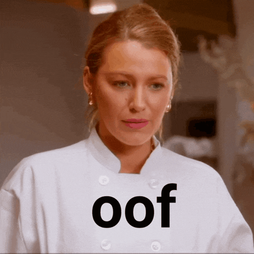 a woman wearing a white chef 's coat has the word oof on her chest